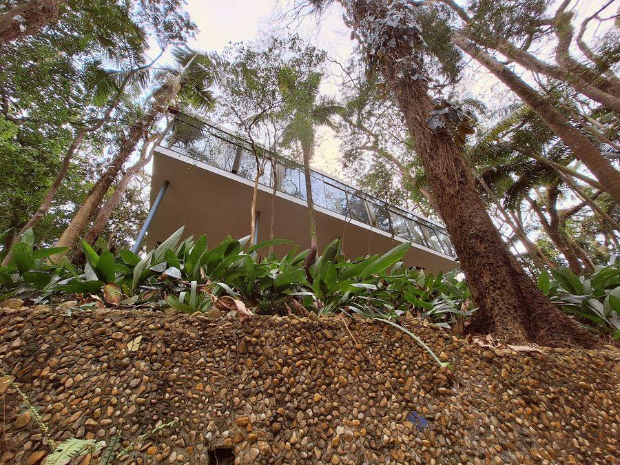 Casa de Vidro, Sao Paulo, the glass enclosed living level seen from below through the Morumbi garden