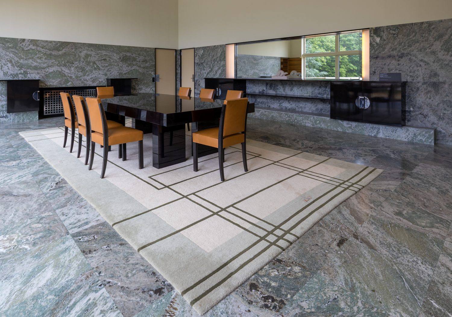The parents' dining room at Villa Cavrois, with green Swedish marble walls and floor and black lacquered furniture.