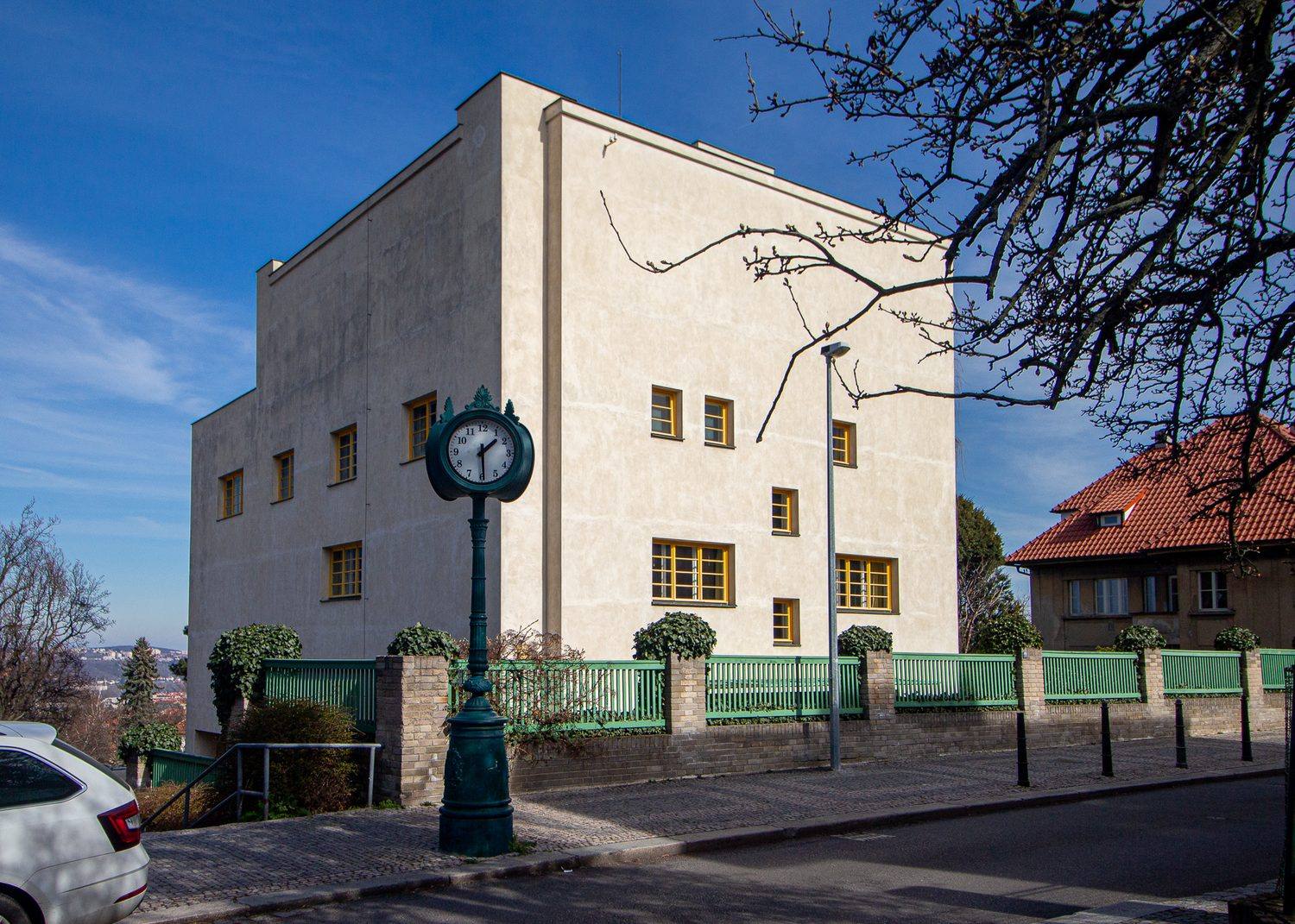 Villa Müller, Prague, seen from the street in Střešovice, its white cubic mass behind a green fence