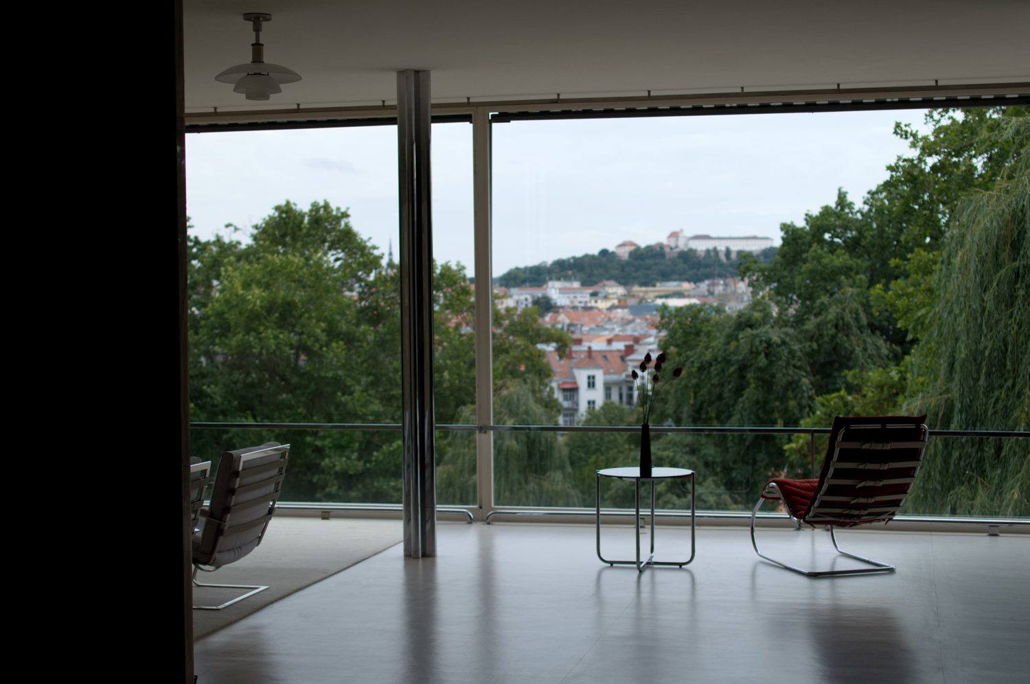 The main living area with its floor to ceiling glass wall opening onto the garden